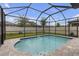 Tranquil screened-in pool featuring a beautiful swimming pool, paved deck, and well-maintained landscaping at 19926 Stone Pine Cir, Lutz, FL 33558