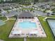 Aerial view of a community pool with lounge chairs, umbrellas, and a covered pavilion at 19926 Stone Pine Cir, Lutz, FL 33558