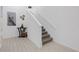 Bright foyer showcasing a staircase with white railings and neutral-toned carpeted steps at 19926 Stone Pine Cir, Lutz, FL 33558
