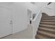 Bright foyer showcasing a staircase with white railings and neutral-toned carpeted steps at 19926 Stone Pine Cir, Lutz, FL 33558