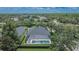 Aerial view of the home with a screened pool in a leafy neighborhood at 20537 Lace Cascade Rd, Land O Lakes, FL 34637
