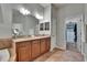 Bathroom featuring double sinks, granite countertop and a doorway to the walk-in closet at 20537 Lace Cascade Rd, Land O Lakes, FL 34637