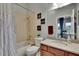 Charming bathroom featuring framed decor, a shower over tub and a vanity with granite countertop at 20537 Lace Cascade Rd, Land O Lakes, FL 34637
