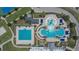 Overhead view of an outdoor recreational pool area featuring a lap pool, leisure pool, and splash pad at 20537 Lace Cascade Rd, Land O Lakes, FL 34637