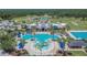 Aerial view of a stunning community pool with splash pad, lap pool, and plenty of seating areas at 20537 Lace Cascade Rd, Land O Lakes, FL 34637