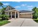 Attractive single-story home featuring a well-manicured lawn, tidy landscaping and welcoming front porch at 20537 Lace Cascade Rd, Land O Lakes, FL 34637