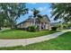 Inviting single-story home featuring a well-manicured lawn, tidy landscaping and welcoming front porch at 20537 Lace Cascade Rd, Land O Lakes, FL 34637