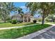 Attractive single-story home featuring a well-manicured lawn, tidy landscaping and welcoming front porch at 20537 Lace Cascade Rd, Land O Lakes, FL 34637