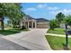 Inviting single-story home featuring a well-manicured lawn, tidy landscaping and welcoming front porch at 20537 Lace Cascade Rd, Land O Lakes, FL 34637