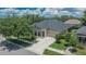 Beautiful view of single-story home featuring a well-manicured lawn, tidy landscaping and welcoming front porch at 20537 Lace Cascade Rd, Land O Lakes, FL 34637