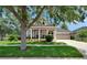 Attractive single-story home featuring a well-manicured lawn, tidy landscaping and welcoming front porch at 20537 Lace Cascade Rd, Land O Lakes, FL 34637