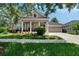 Charming single-story home with manicured lawn and a welcoming front porch with white columns at 20537 Lace Cascade Rd, Land O Lakes, FL 34637
