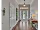 Inviting hallway with hardwood floors, a decorative mirror, and a stylish console table with lamp at 20537 Lace Cascade Rd, Land O Lakes, FL 34637