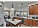 Open kitchen featuring granite counters, stainless appliances, an island, and wood cabinetry at 20537 Lace Cascade Rd, Land O Lakes, FL 34637
