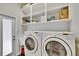 Functional laundry room featuring a new washer and dryer, plenty of storage and a utility sink at 20537 Lace Cascade Rd, Land O Lakes, FL 34637