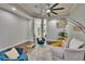 Bright living room with recessed lighting, ceiling fan, and stylish blue accent chairs at 20537 Lace Cascade Rd, Land O Lakes, FL 34637