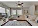 Cozy living room with hardwood floors, fan, natural light, and a comfortable sectional sofa at 20537 Lace Cascade Rd, Land O Lakes, FL 34637