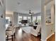 Open-concept living room with a ceiling fan, hardwood floors, and an abundance of natural light at 20537 Lace Cascade Rd, Land O Lakes, FL 34637