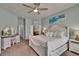 Comfortable main bedroom featuring a ceiling fan, a bed with storage and natural light at 20537 Lace Cascade Rd, Land O Lakes, FL 34637