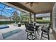 Spacious outdoor patio with ample seating, lounge chairs, and a fire pit overlooking the pool at 20537 Lace Cascade Rd, Land O Lakes, FL 34637