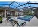 The screened-in patio features a pool, spa, lounge chairs, and outdoor seating, ideal for outdoor relaxation and entertaining at 20537 Lace Cascade Rd, Land O Lakes, FL 34637