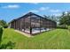 Lush backyard featuring a screened pool and spa, perfect for outdoor entertainment and relaxation in a private setting at 20537 Lace Cascade Rd, Land O Lakes, FL 34637