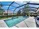Beautifully screened pool area with comfortable seating, a spa, and serene water features for a luxurious outdoor experience at 20537 Lace Cascade Rd, Land O Lakes, FL 34637