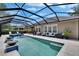 A stunning pool area with a screened enclosure, comfortable seating, and lush landscaping for ultimate privacy and enjoyment at 20537 Lace Cascade Rd, Land O Lakes, FL 34637
