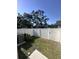 Backyard features a white fence, green grass, and shade from a mature tree at 2108 E 22Nd Ave # 1, Tampa, FL 33605