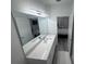 Modern bathroom features dual sinks, a granite countertop, and an adjacent bedroom at 2108 E 22Nd Ave # 1, Tampa, FL 33605