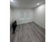 Bright empty bedroom features light gray floors, two windows, and a wall-mounted TV at 2108 E 22Nd Ave # 1, Tampa, FL 33605