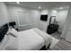Modern bedroom features a bed with black nightstands, a dresser, and gray wood floors at 2108 E 22Nd Ave # 1, Tampa, FL 33605