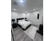 Bedroom features gray wood floors, a bed with nightstands, and two windows at 2108 E 22Nd Ave # 1, Tampa, FL 33605