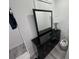 Modern black dresser featuring a sleek mirror and a stylish lamp at 2108 E 22Nd Ave # 1, Tampa, FL 33605