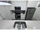 Close-up of a kitchen featuring stainless steel appliances and quartz countertop with sink and modern faucet at 2108 E 22Nd Ave # 1, Tampa, FL 33605