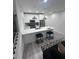Modern kitchen boasts stainless steel appliances, white cabinets, a quartz countertop and pendant lighting at 2108 E 22Nd Ave # 1, Tampa, FL 33605