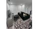 Contemporary living room features a plush black sofa, stylish rug, and abundant natural light at 2108 E 22Nd Ave # 1, Tampa, FL 33605