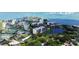 An aerial view shows surrounding waterways, other buildings, and trees at 220 Belleview Blvd # 104, Belleair, FL 33756