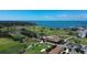 Breathtaking aerial view showcases the golf course, waterfront, and surrounding residential area at 220 Belleview Blvd # 104, Belleair, FL 33756
