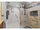 Updated bathroom featuring a glass enclosed tile shower with mosaic accents and convenient grab bars at 220 Belleview Blvd # 104, Belleair, FL 33756