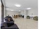 Common room with couches, tables, and chairs for residents to relax and enjoy at 220 Belleview Blvd # 104, Belleair, FL 33756