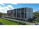 Spacious condo building with multiple balconies and covered parking, providing ample space for comfortable living at 220 Belleview Blvd # 104, Belleair, FL 33756
