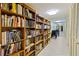 Hallway with floor to ceiling bookshelves filled with books and wheelchair access at 220 Belleview Blvd # 104, Belleair, FL 33756
