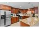 Well-equipped kitchen boasts stainless steel appliances, granite countertops, and wooden cabinetry at 220 Belleview Blvd # 104, Belleair, FL 33756