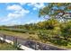 Scenic view of a tranquil lake surrounded by lush greenery and a clear sky at 220 Belleview Blvd # 104, Belleair, FL 33756