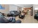 Bright and airy living room with open layout, neutral tones, tile floors, and a glimpse of the kitchen at 220 Belleview Blvd # 104, Belleair, FL 33756