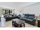 Inviting living room featuring tile floors, comfortable seating, and beautiful natural light at 220 Belleview Blvd # 104, Belleair, FL 33756
