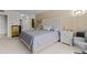 Serene bedroom featuring a carved headboard, soft lighting, carpet, and neutral tones for a relaxing atmosphere at 220 Belleview Blvd # 104, Belleair, FL 33756