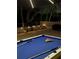 Well-lit outdoor patio at night, showcasing a pool table ready for a game at 220 Belleview Blvd # 104, Belleair, FL 33756