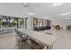 Bright sitting area featuring large windows, tile floors, and ample seating at 220 Belleview Blvd # 104, Belleair, FL 33756